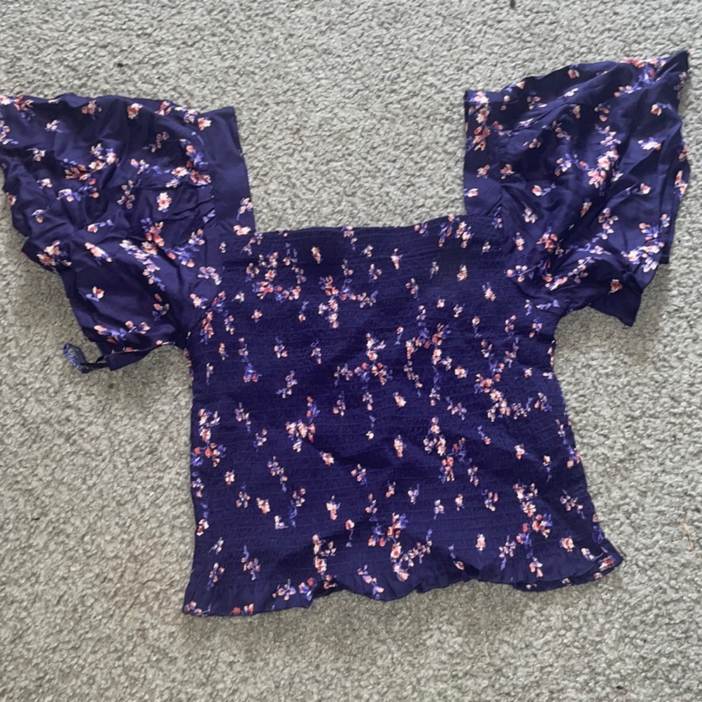 It is a ribbed elastic blouse/crop top with pretty floral design.